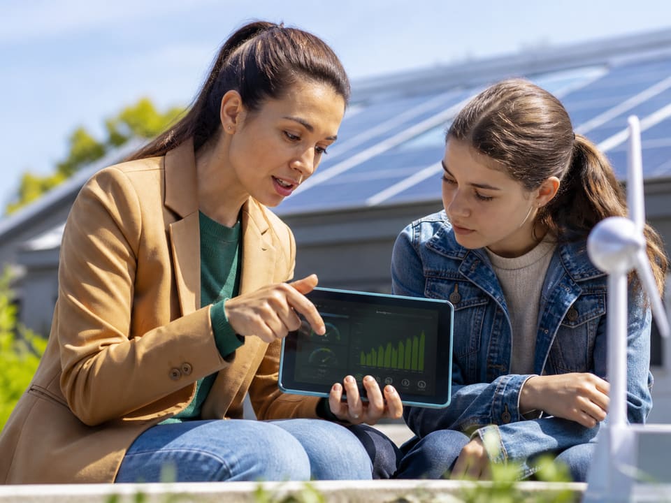 Educator discussing green energy with a student